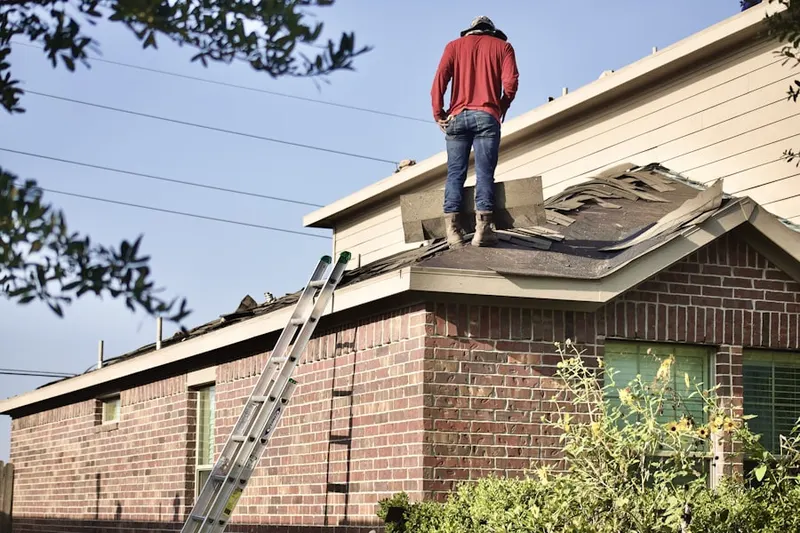 Professional roofer working on a residential roof in Liberty Gardens